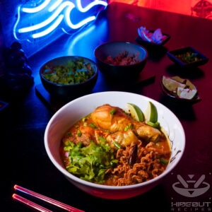 Food photo with a futuristic Cyberpunk style. A bowl of Khao Soi Chiang Mai with garnish and chopsticks.