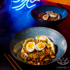 A futuristic Cyberpunk-style food photo. Two bowls of Rabokki (instant ramen in a Korean Tteokbokki sauce) with various toppings.