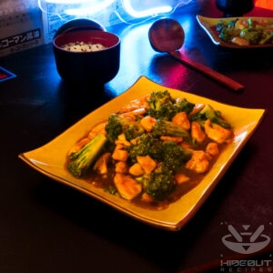 A futuristic Cyberpunk-style food photo showing a plate of Chinese takeout-style Broccoli and Chicken stir fry on a plate. A small bowl of rice and chopsticks are next to it, and another set of food in the background.