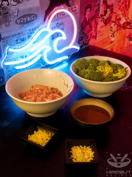 Raw, chopped ingredients for Chinese takeout-style Broccoli and Chicken stir fry are gathered on a table. The sauce is pre-mixed in a bowl.