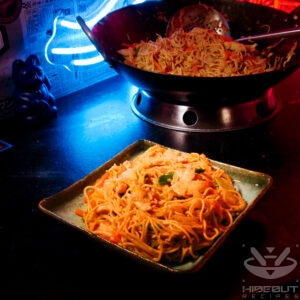 A futuristic Cyberpunk-style food photo showing a plate of Chinese Chow Mein noodles in the foreground and a wok with more in the back.