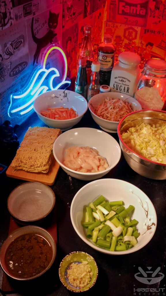 Pre-portioned and processed raw ingredients for Chow Mein are distributed to small bowls on a table.