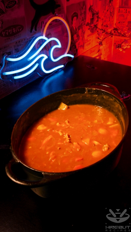 A large cast-iron pot containing Japanese chicken curry.