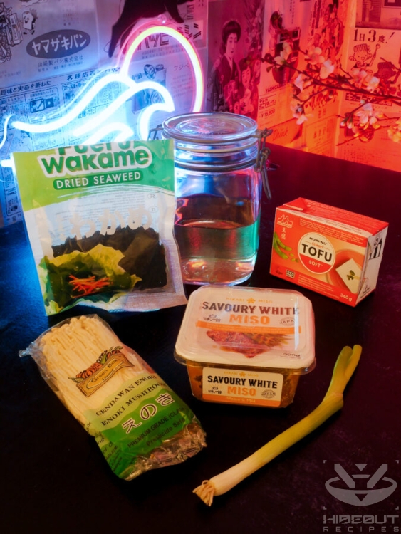 Unprocessed ingredients for Japanese miso soup are placed on a table in their packaging.