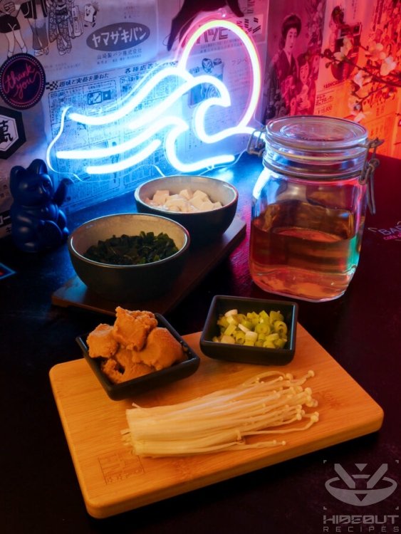 Pre-measured, processed raw ingredients for Japanese miso soup are placed on a table.