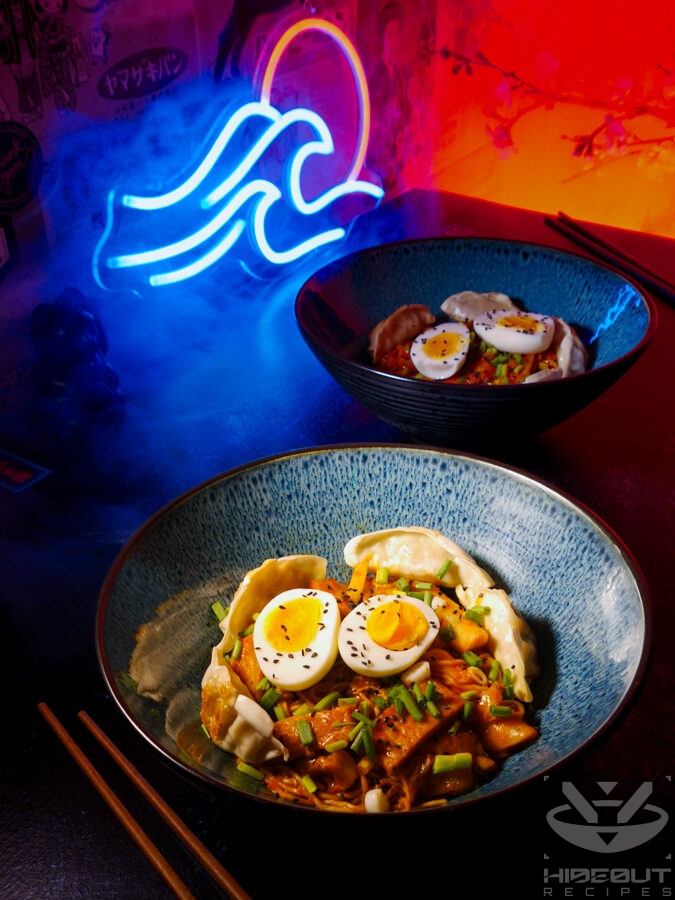 A futuristic Cyberpunk-style food photo. Close-up of a bowl of Rabokki (instant ramen in a Korean Tteokbokki sauce) with various toppings and a second bowl in the background.
