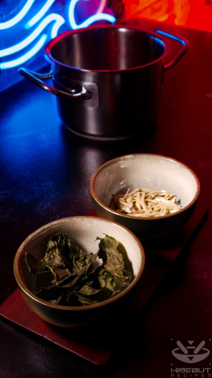 A pot of water and bowls of kombu seaweed and anchovies for a Korean-style broth.