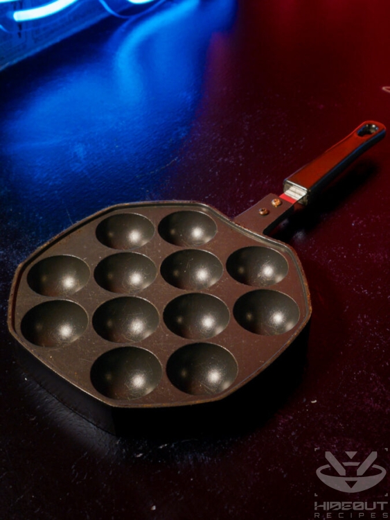 A small Takoyaki pan for use on a stove.