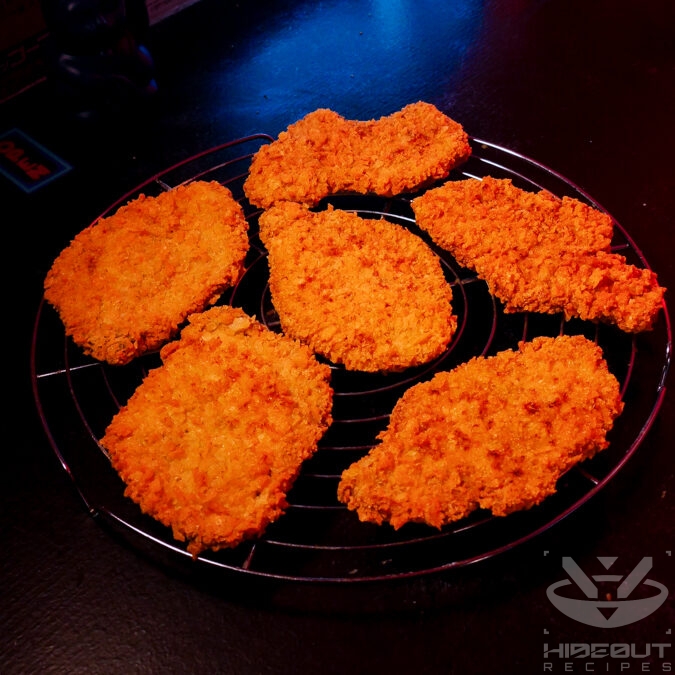 Six Tonkatsu cutlets are placed on a wire rack. They have been deep-fried twice and have a deep golden-orange color.