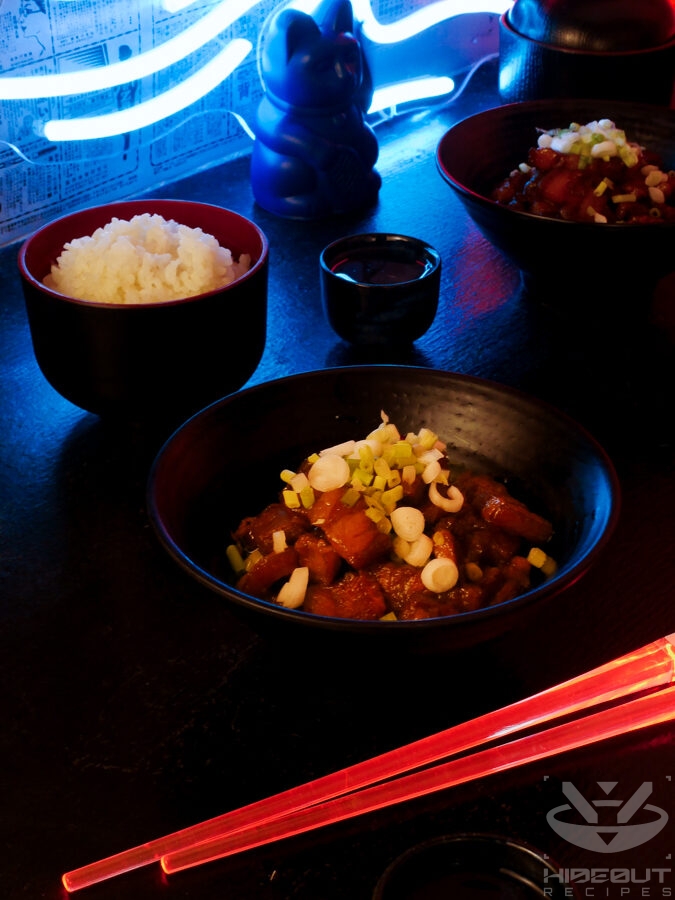 A futuristic Cyberpunk food photo. A bowl of oven-braised Kakuni (Japanese pork belly) is at the center, with a bowl of rice, chopsticks, and a cup of Sake around it.
