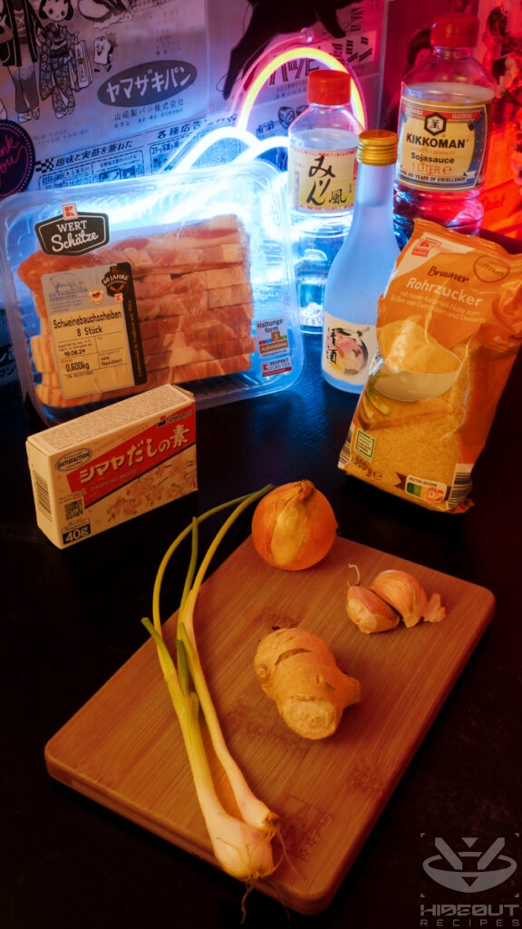 Ingredients for Kakuni (Japanese pork belly) are spread around the table in their packaging. Scallions, ginger, garlic, and an onion lie on a wooden board.