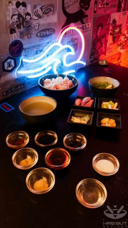 Pre-measured and chopped ingredients for Chinese Ginger Chicken are distributed to small bowls on a table.