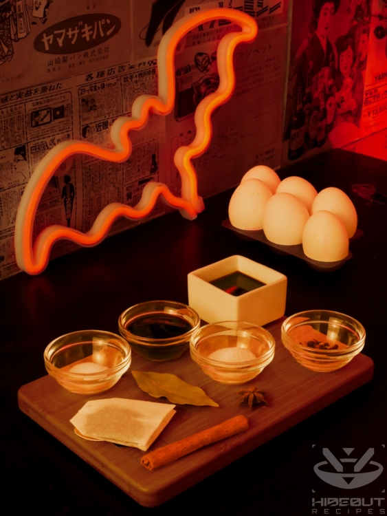 Pre-measured ingredients for Chinese Tea Eggs are distributed to small bowls on a table, with six uncooked eggs in the background.