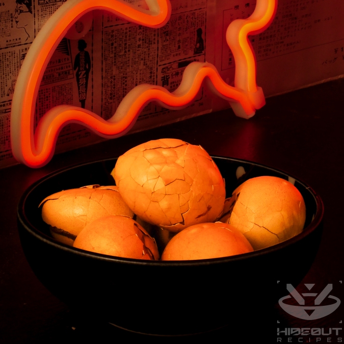 Six marinated Chinese Tea Eggs with the cracked shell still on are lying in a bowl.