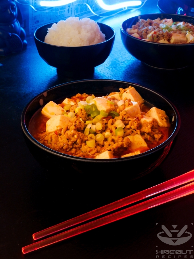 A futuristic Cyberpunk-style food photo showing two bowls of Chinese (Sichuan) Mapo Tofu with bowls of rice and a pair of glowing chopsticks in the foreground.