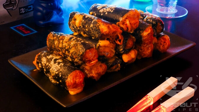 A futuristic Cyberpunk-style food photo. Spring rolls containing noodles in a spicy sauce, nori, and cheese are stacked up on a plate.