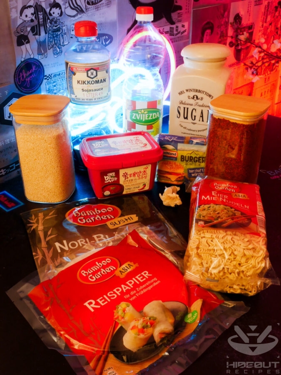 Ingredients for spicy noodle spring rolls are gathered on a table in their packaging.