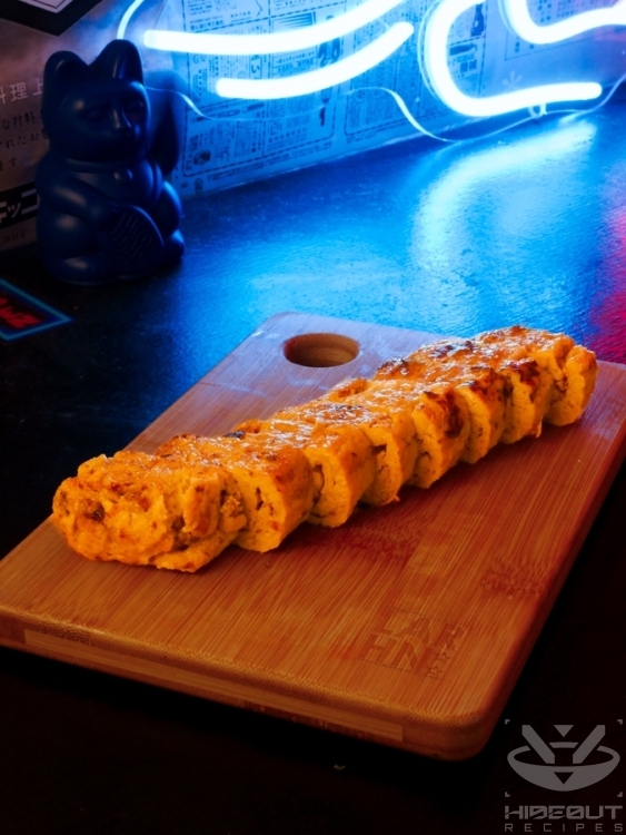 A futuristic Cyberpunk-style food photo of Tamagoyaki sliced into bite-sized pieces.