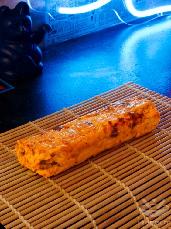 Finished Tamagoyaki is placed on a small bamboo mat.