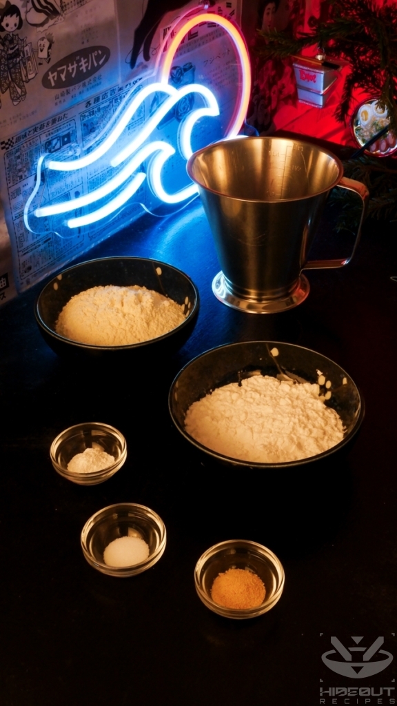 The pre-measured ingredients for Korean Fried Chicken batter are gathered on a table in various bowls.