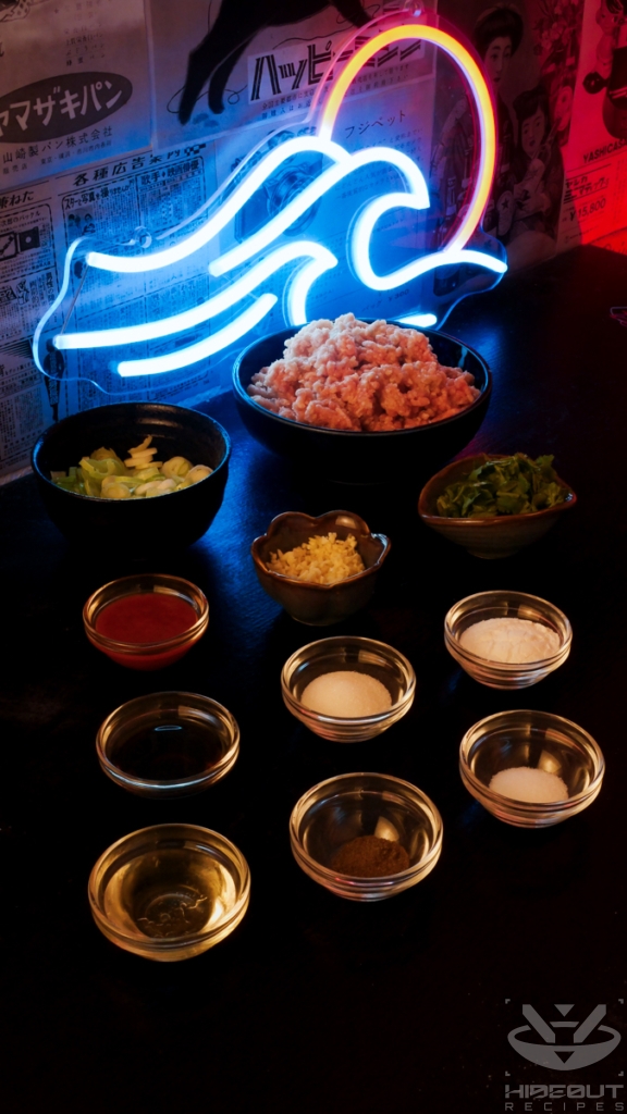 The pre-measured ingredients for meat balls are distributed on a table, with many small bowls in the foreground and vegetables and minced meat in the back.